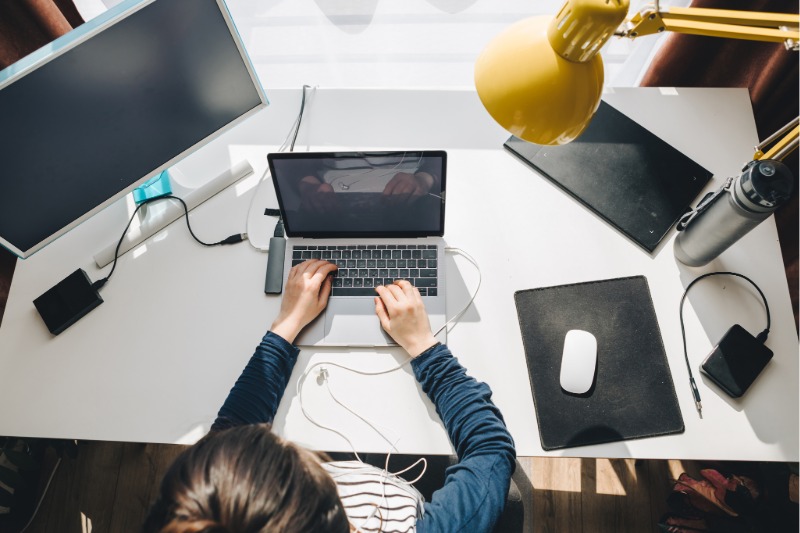 Person working on a laptop at a desk